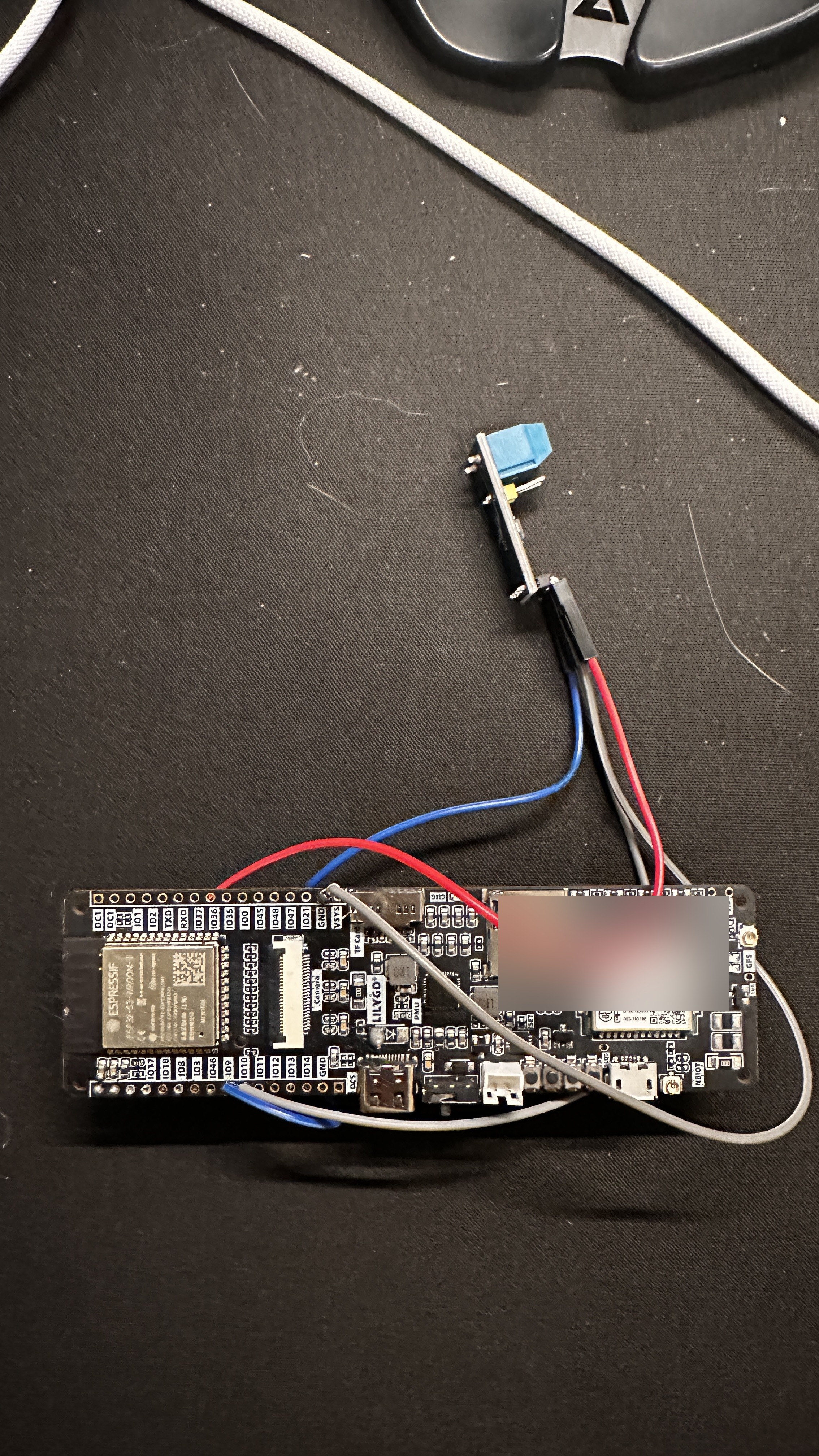 A LilyGo T-SIM7080G board wired to a CAN transceiver breakout and OBD connector. The first hardware to touch the car's B-CAN bus.